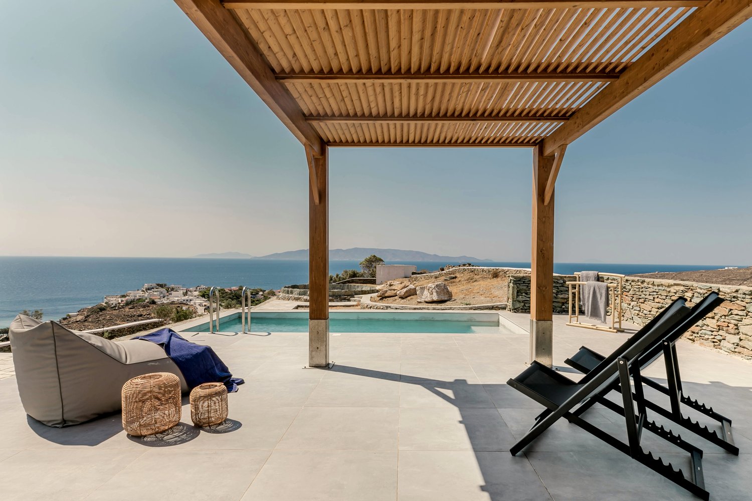 Verros Hut's pergola terrace and sun loungers overlooking the Aegean