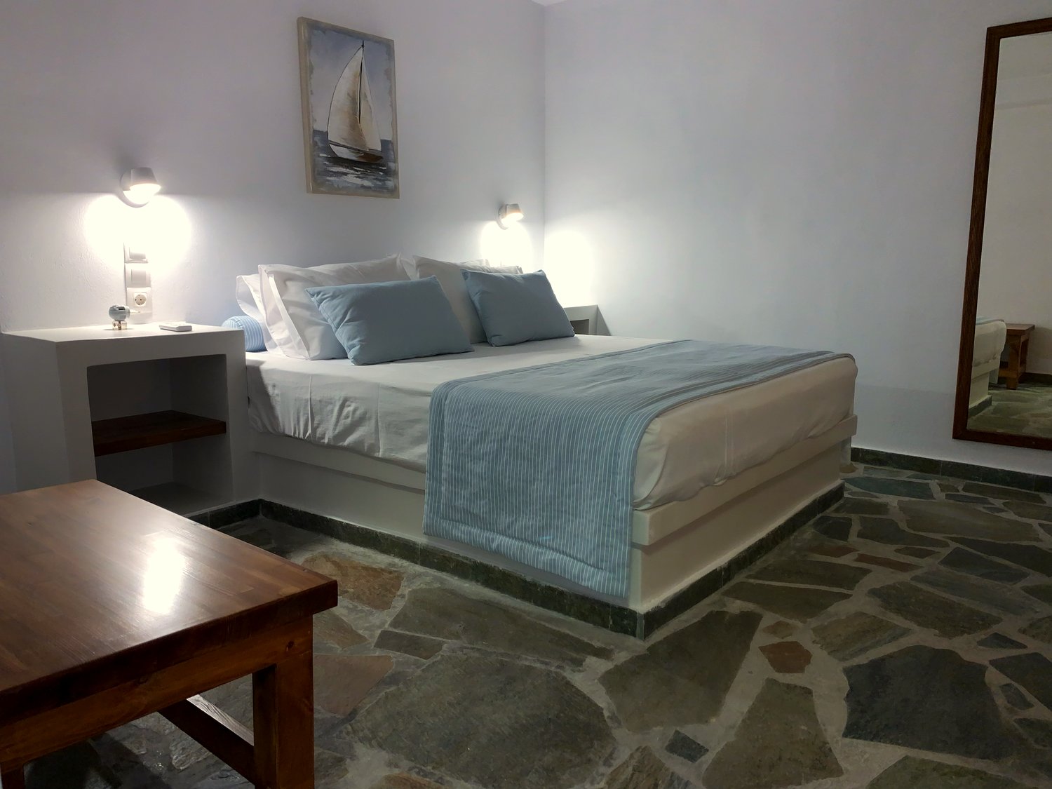 The queen bedroom of Verros Suite with sea-blue linens
