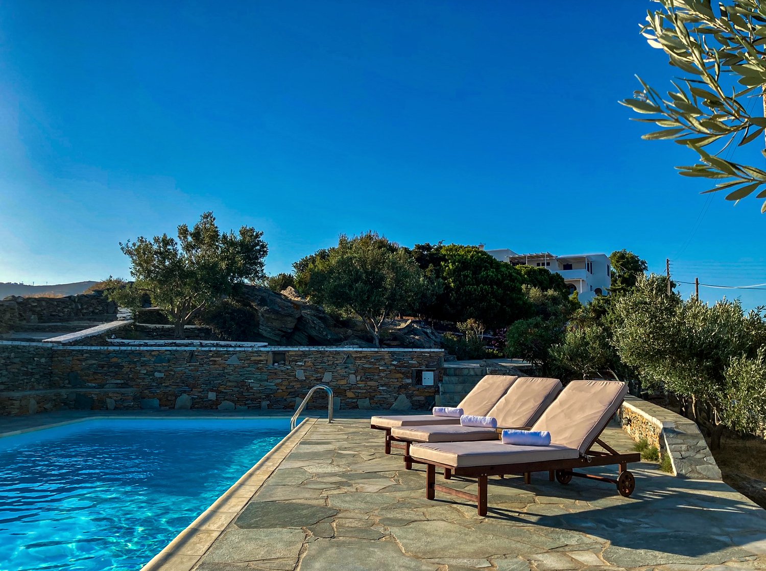Verros Suite — a sea-view deck with sun loungers above the Aegean